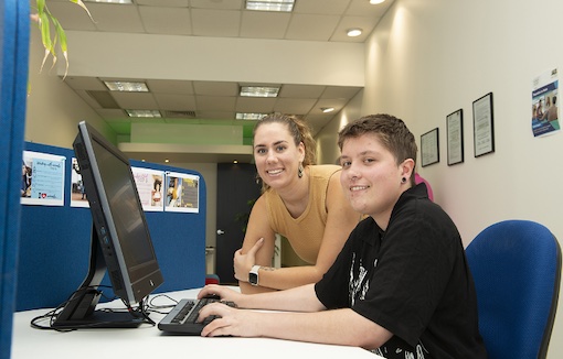 alt="An OCTEC participant getting help with the computer"