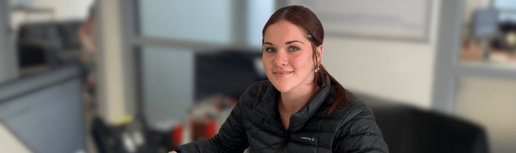 Woman sitting in an office environment.