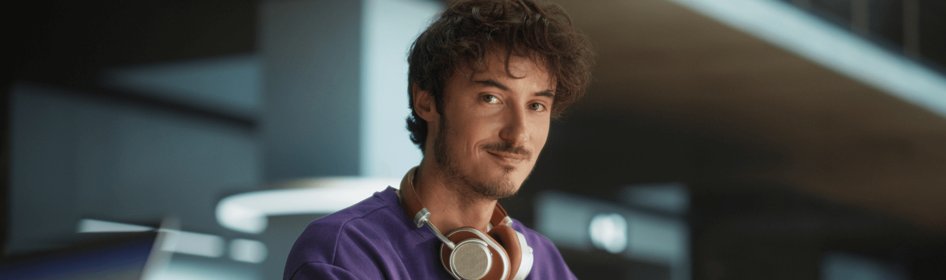 Person wearing headphones in modern setting.